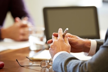 Financial Avisors hands on a conference table